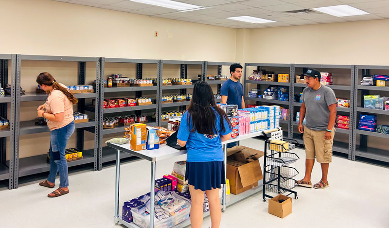 Students at the Eagle Pass Cowboy Pantry shopping for foods items.