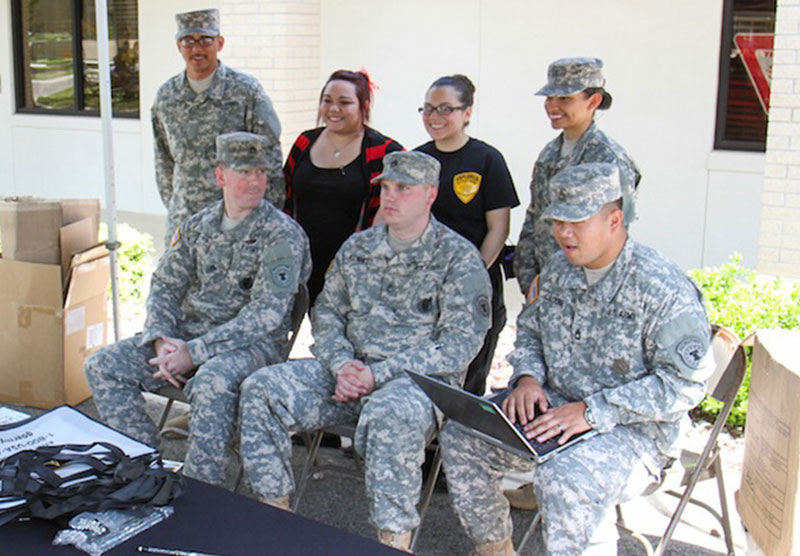 military personnel sitting in a group