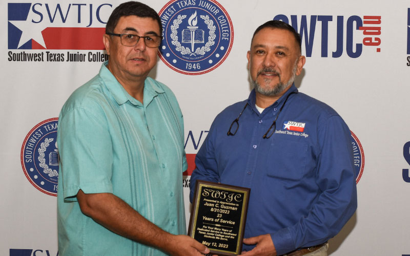 SWTJC President Dr. Hector Gonzales poses with Dean of Applied Sciences and Workforce Education Johnny Guzman, a retiree, having 24 years of service.